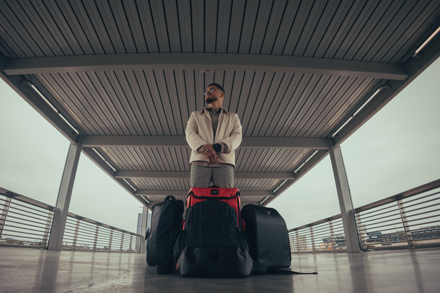 Kevin Michael Chong standing behind a collection of Gruv Gear bags