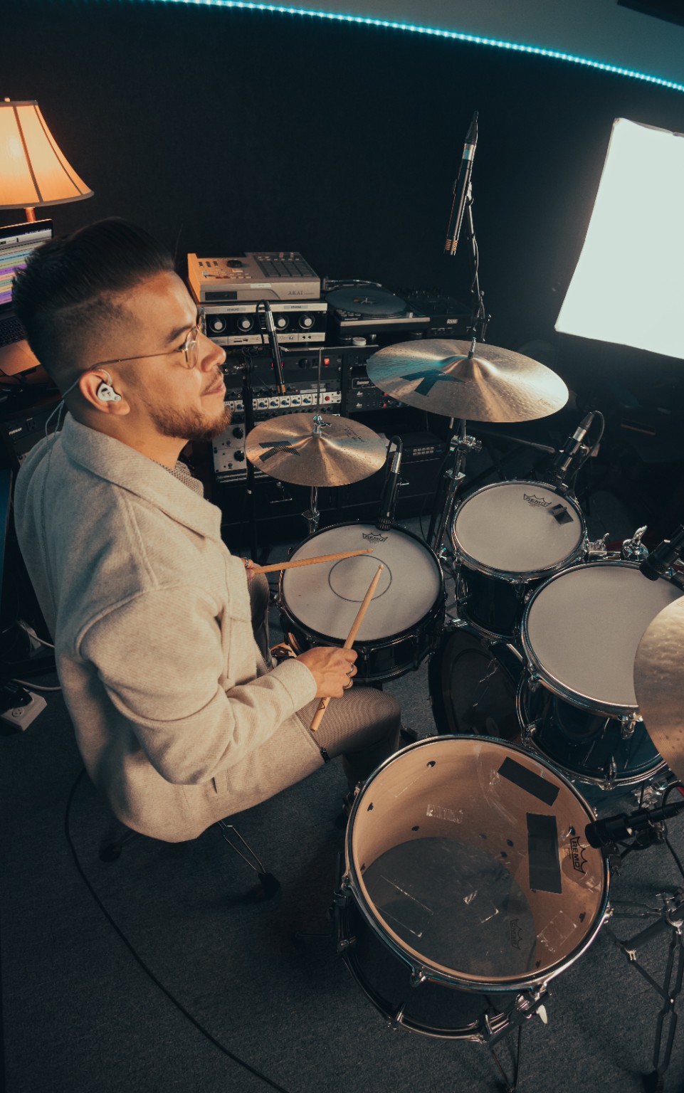 Kevin Michael Chong holding drumsticks behind his kit during an Audix session