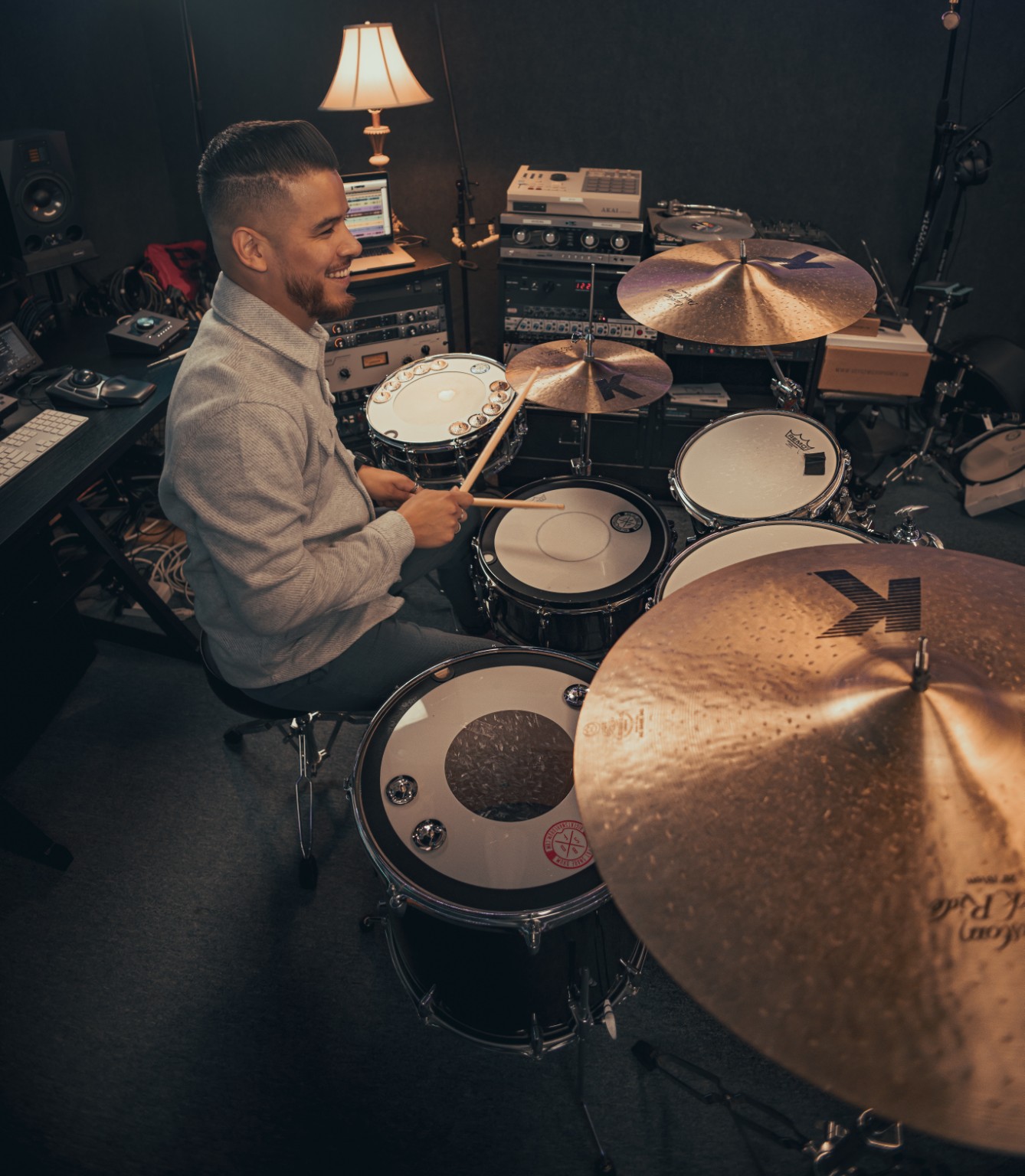 Kevin Michael Chong smiling while playing drums during a Big Fat Snare Drum session